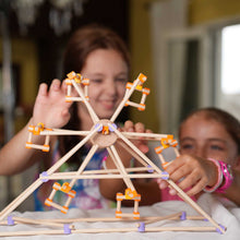 Children building a tall Beaver wooden structure together